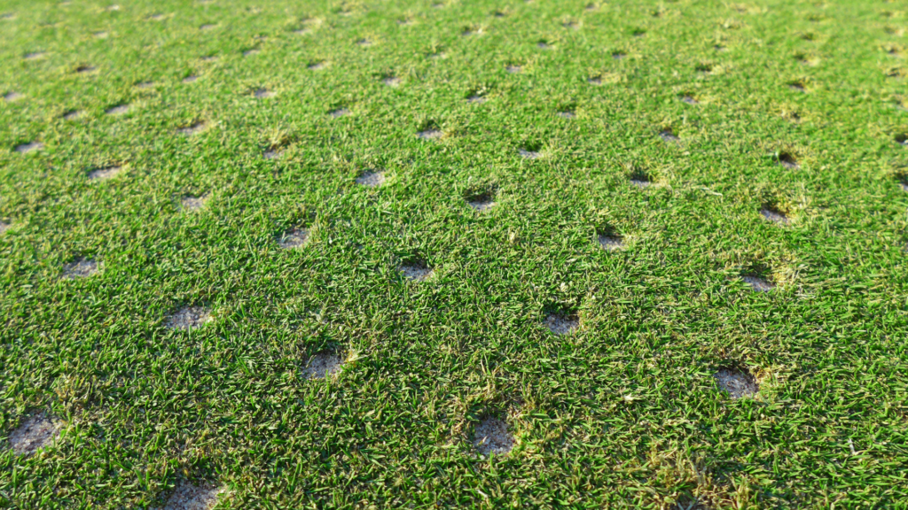 A close-up of soil going through the aeration process